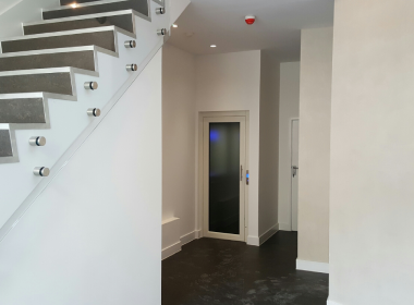 Luxury lift in contemporary home with marble flooring.