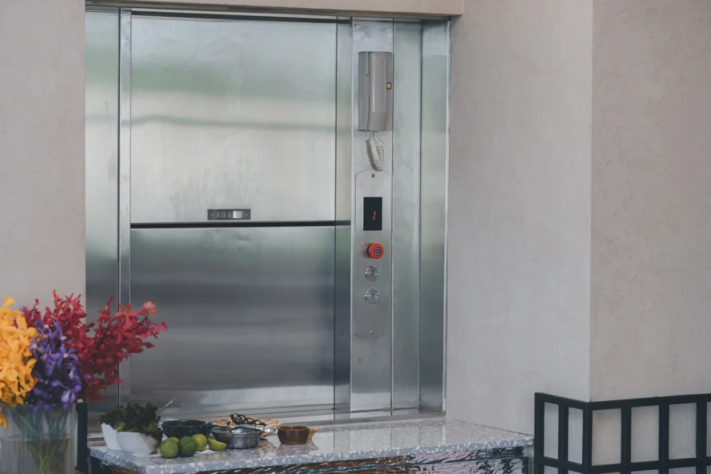 Dumbwaiter lift installed in a serving hatch for transporting items between floors