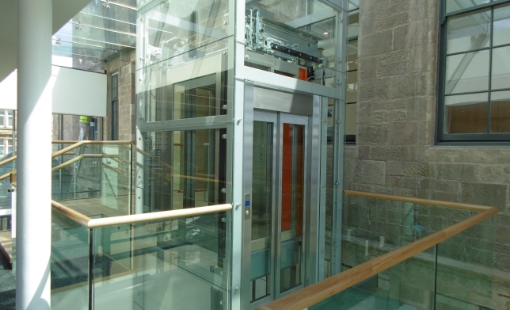 Modern elevator with glass doors and scenic view