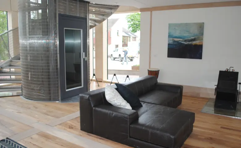 Wheelchair accessible home lift with a user entering the lift car